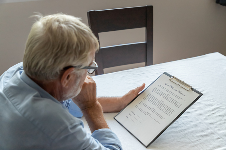 Senior man examining last will and testament