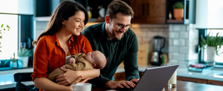 Couple going over home finances with a newborn