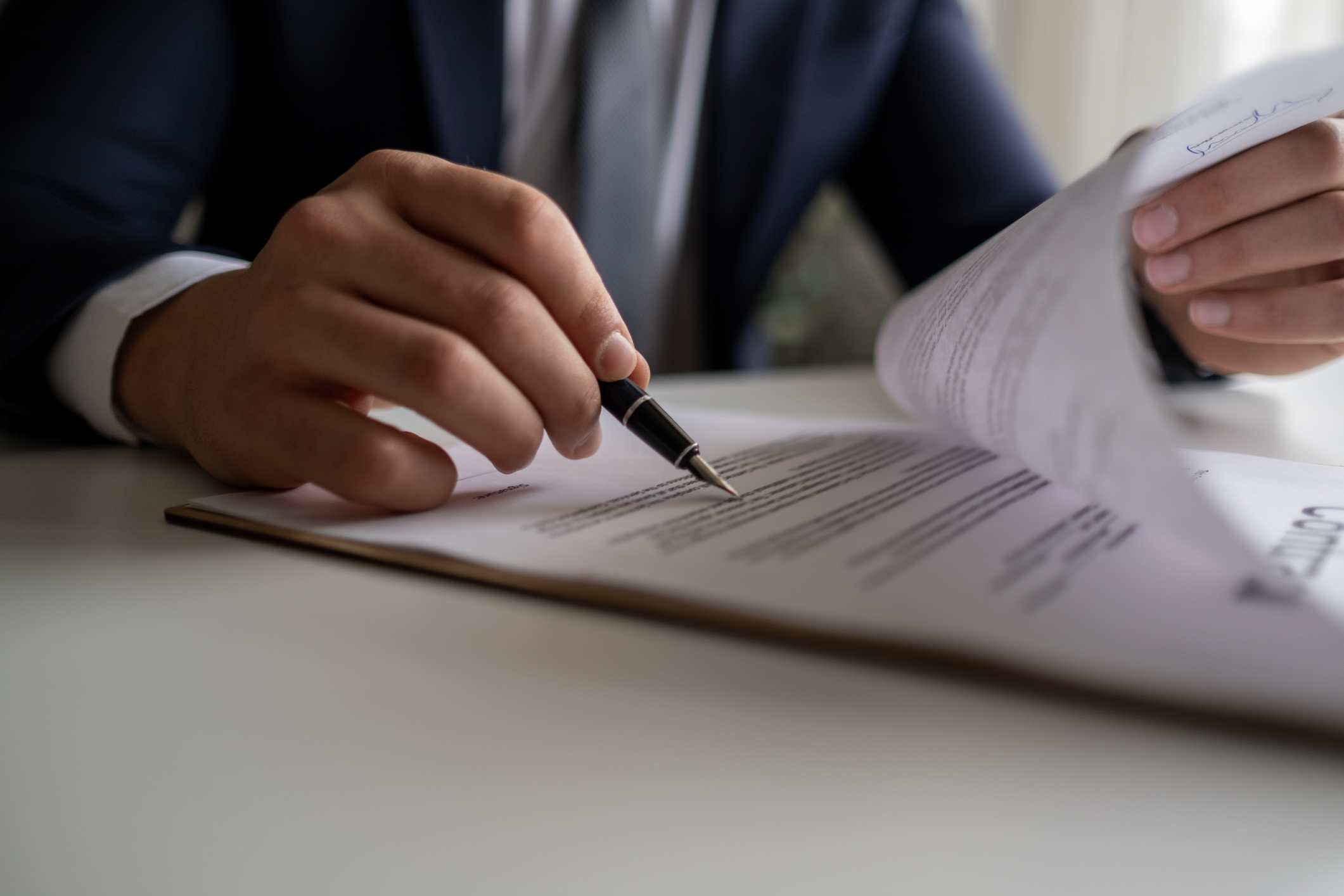 Judge or Legal advisor lawyer examining and signing legal documents.