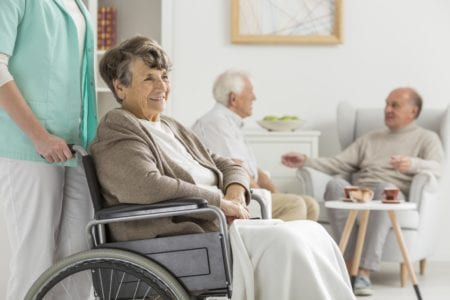 woman in wheel chair in nursing home
